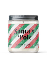 Load image into Gallery viewer, A clear glass jar with a black metal lid labeled 'Santa's Pole' with a green and red striped pattern and white text, indicating it is a soy candle with a Christmas-themed label.
